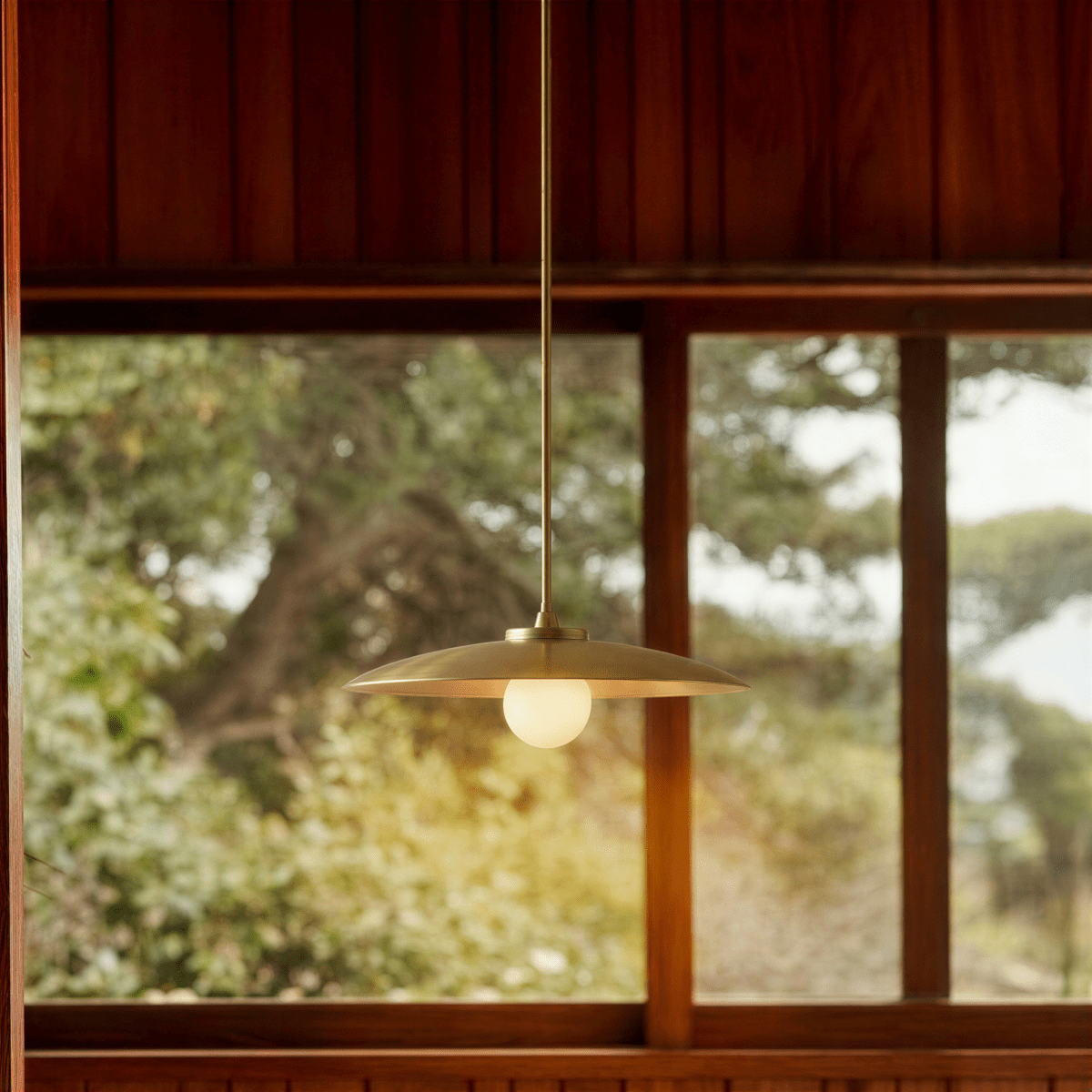 Apsis Metal Pendant Light, second lit and hanging in a styled room