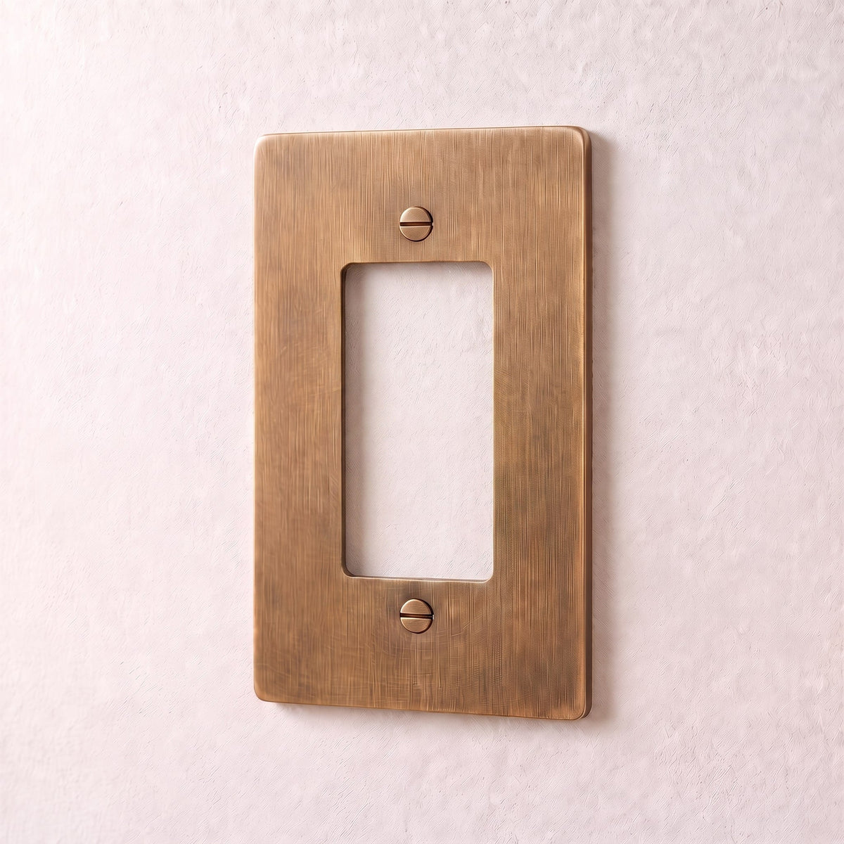Brass Wall Plate (1-5 Gang), held in hand for scale