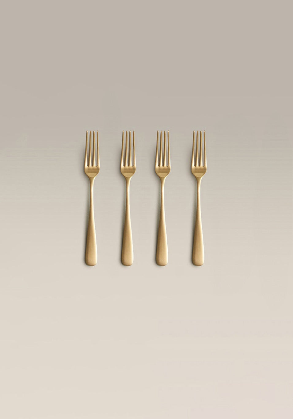 Classic Small Fork Set, gold, single piece on a plain surface