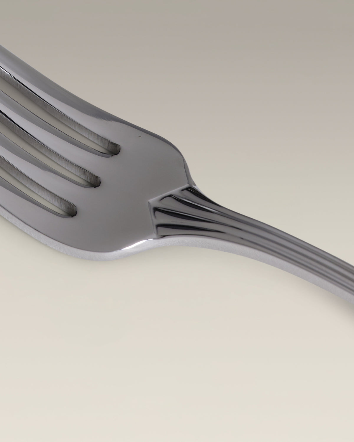 Crescent Four-Person Settings Flatware Set, held in hand for scale