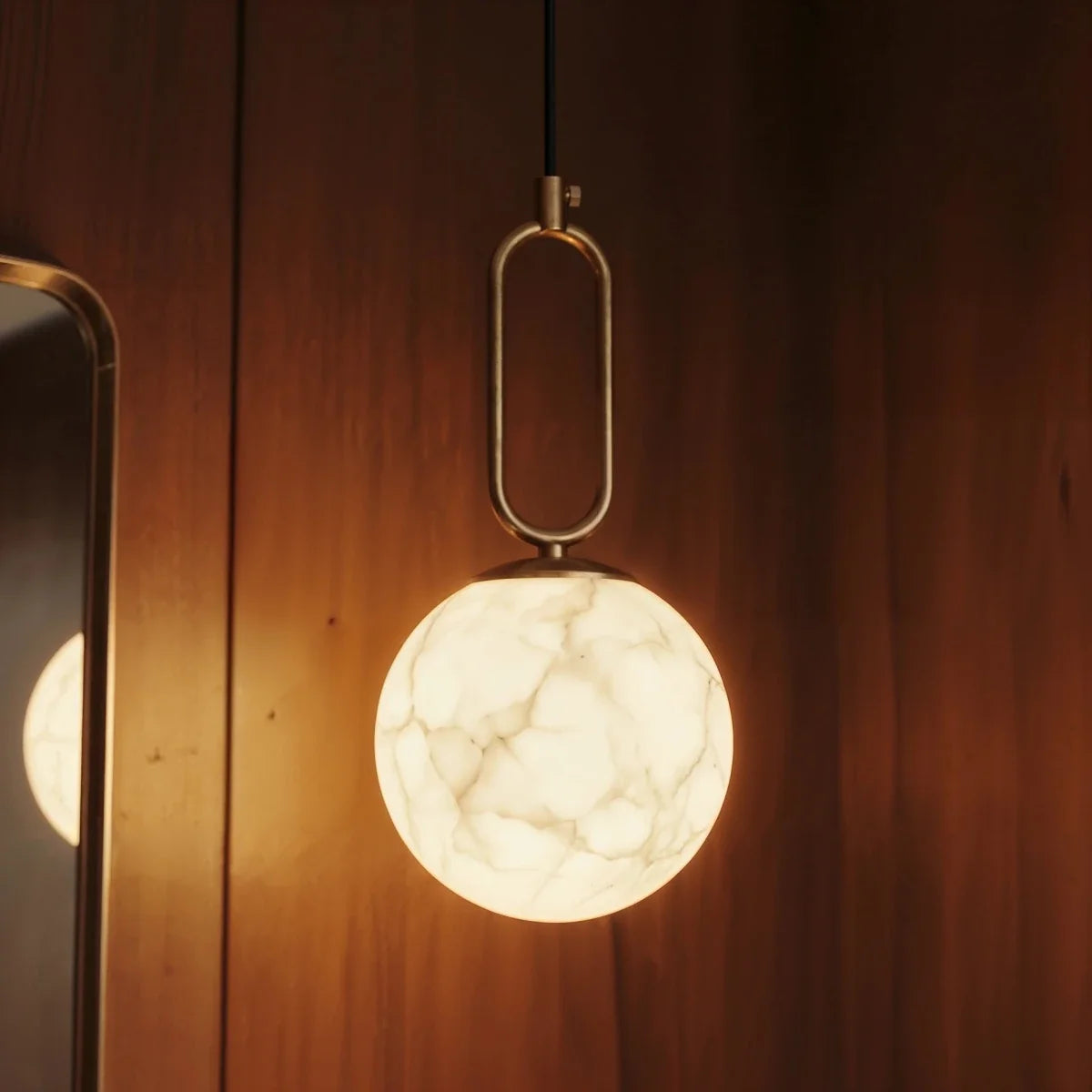 Gong Alabaster Pendant Light, second lit and hanging in a styled room