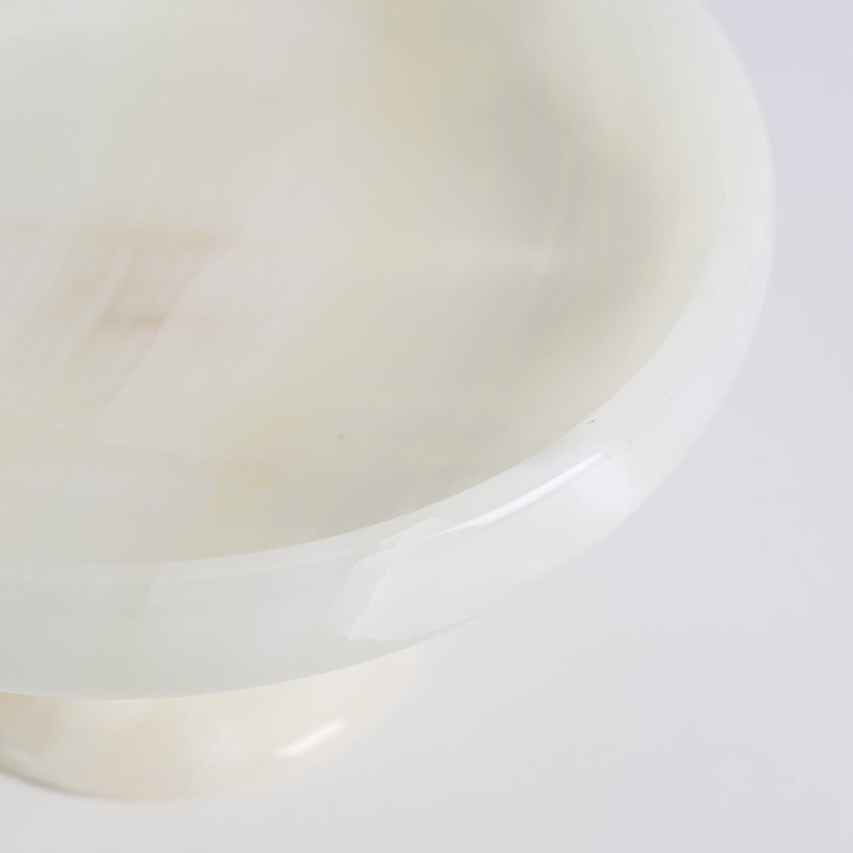 Harlow White Onyx Pedestal Bowl, second held in hand for scale