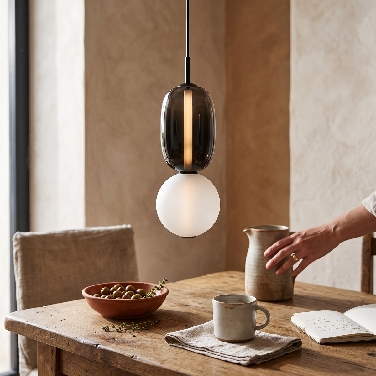 Horiz Metal Pendant Light, lit and hanging in a styled room