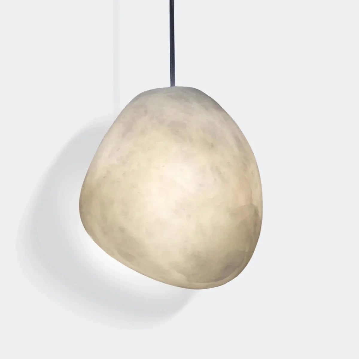 Lapis Alabaster Pendant Light, second lit and hanging in a styled room
