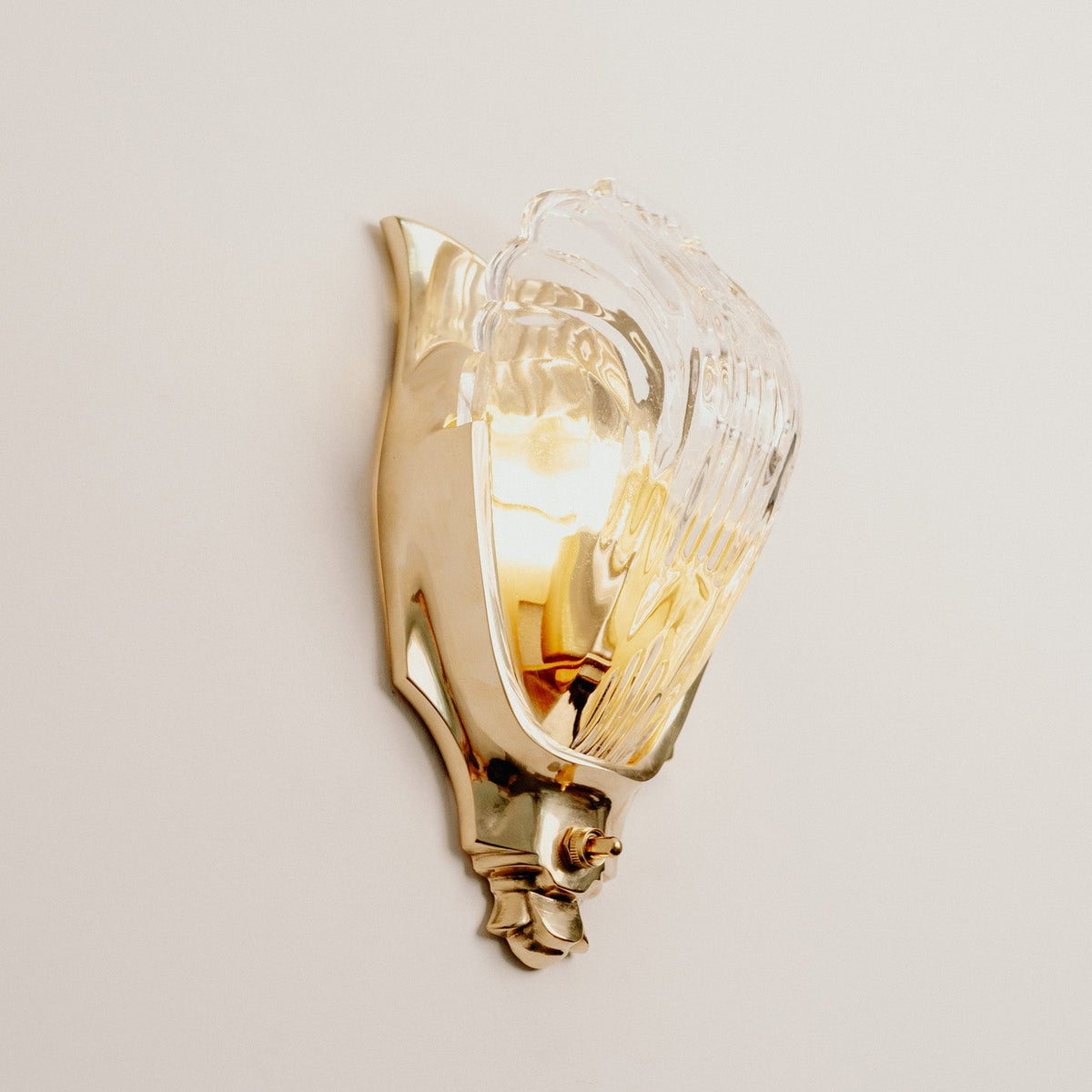 Lilith Brass Antique Art Deco Wall Light, fixture lit in a room
