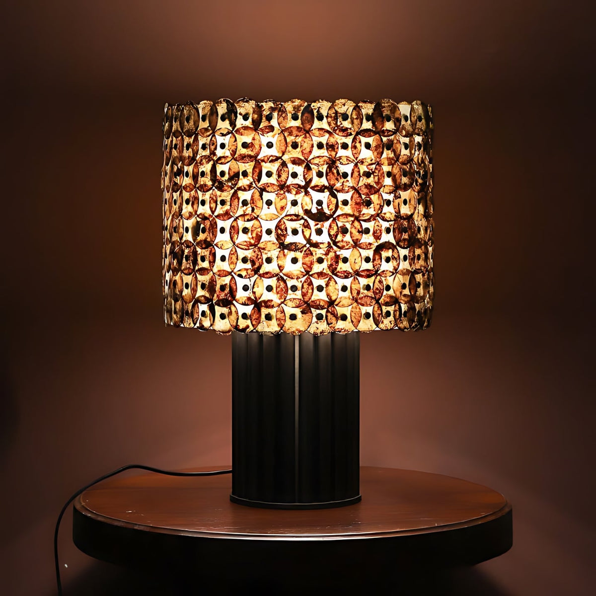 Naerix Shell Table Lamp, second lit on a side table