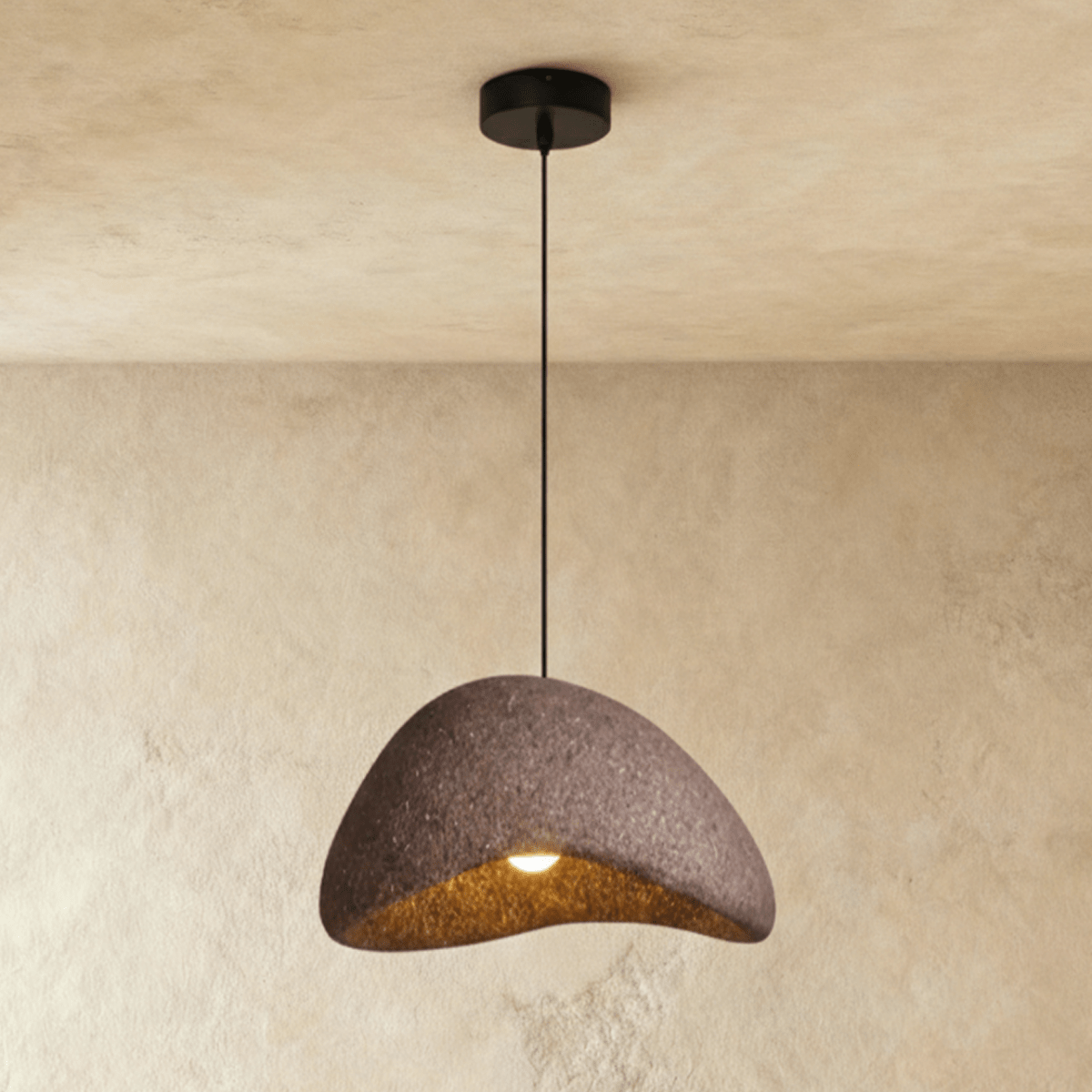 Shibui Sand Metal Pendant Light, second lit and hanging in a styled room