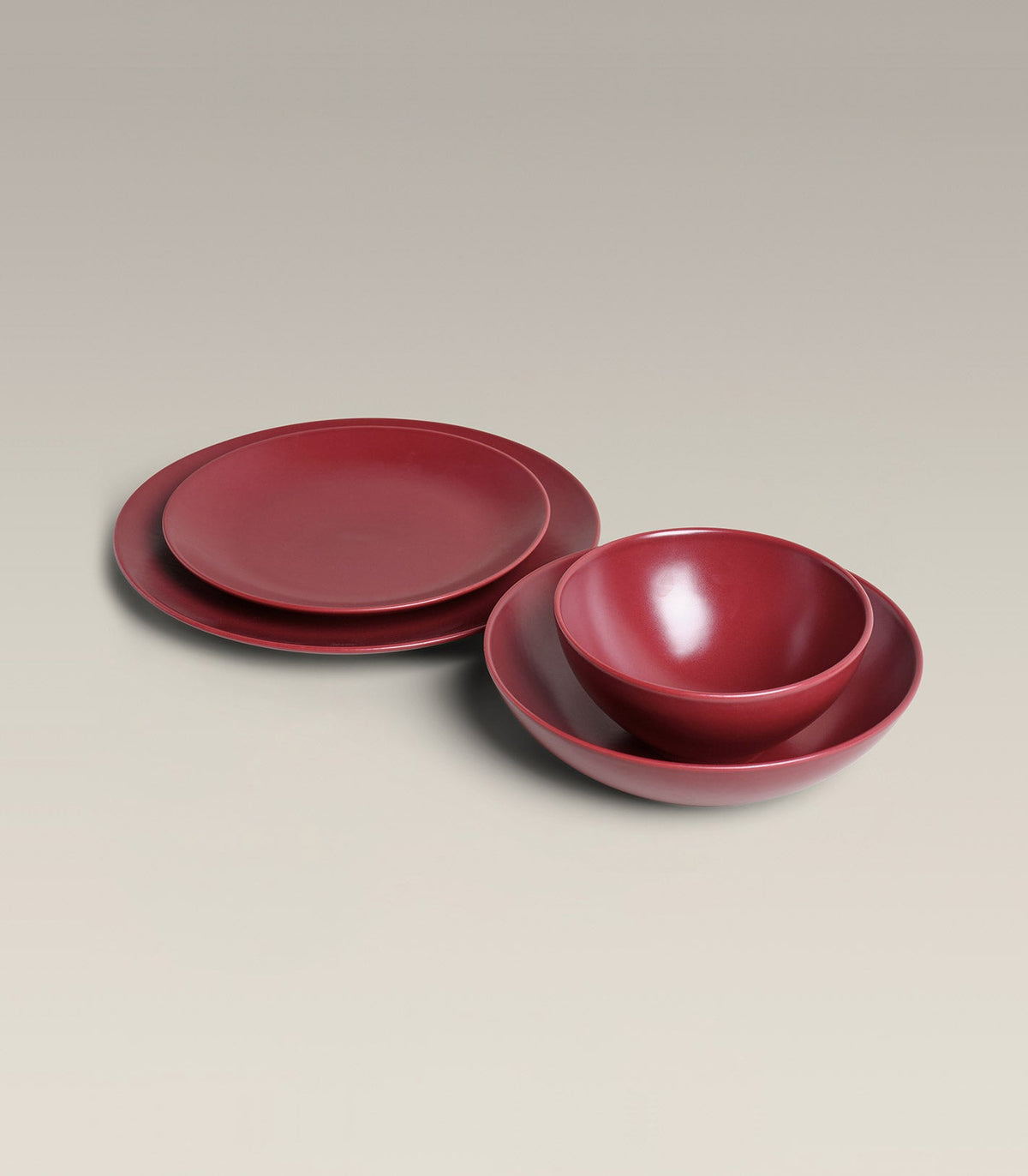 Stoneware Core Set, Plum, held in hand for scale
