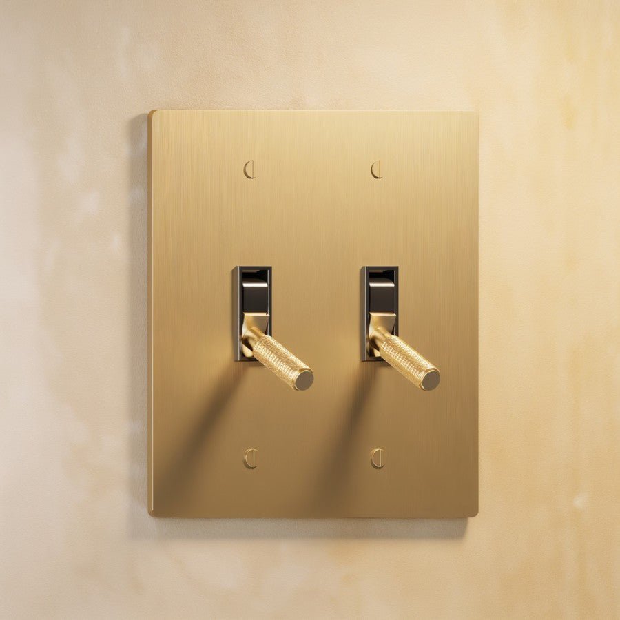The Architectural Brass 4-Way Toggle Switch (1 to 5 Gang), installed on the wall