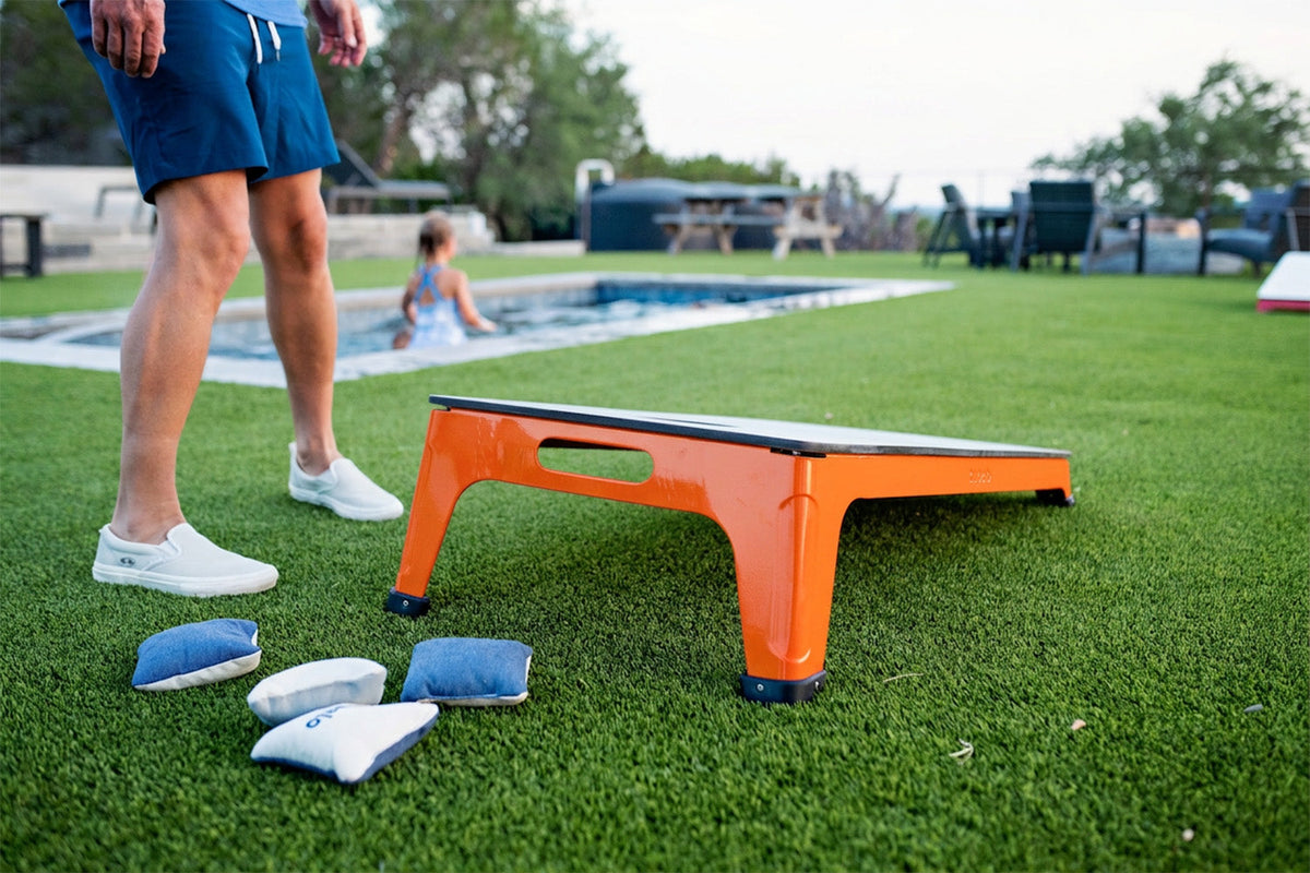 All-Weather Cornhole Set, orange, styled in a real room