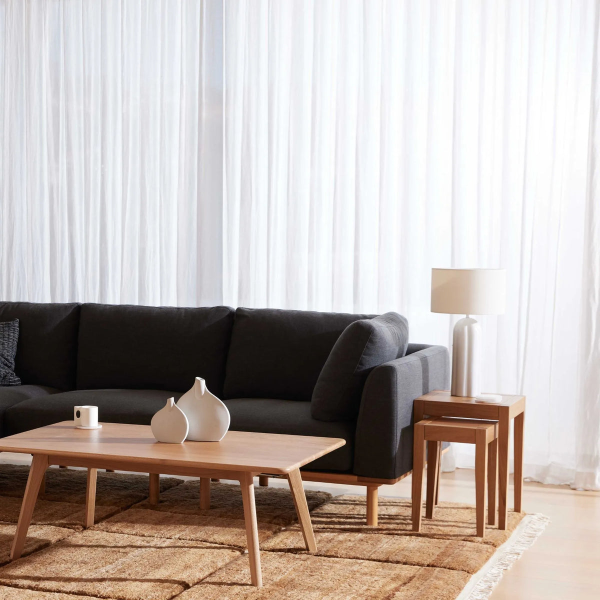 Anika Modular Sofa, coal grey, styled in a living room