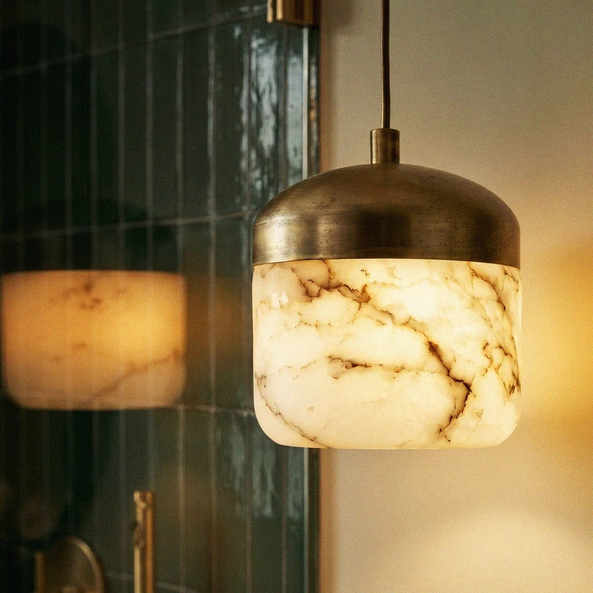 Asta Alabaster Pendant Light, second lit and hanging in a styled room
