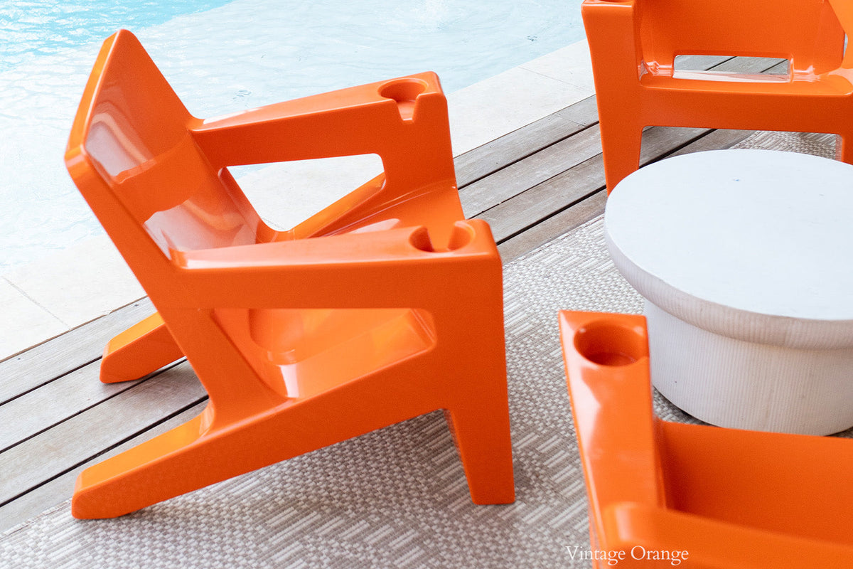Bask Outdoor Lounge Chair, orange, styled in a real room