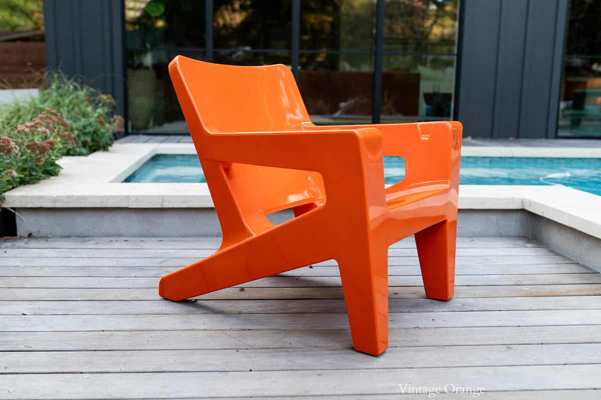 Bask Outdoor Lounge Chair, orange, styled in a living space