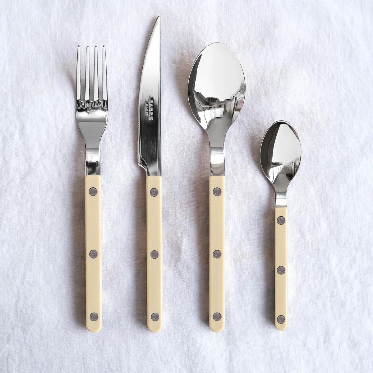 Bistrot Ivory Stoneware Flatware, single piece on a plain surface