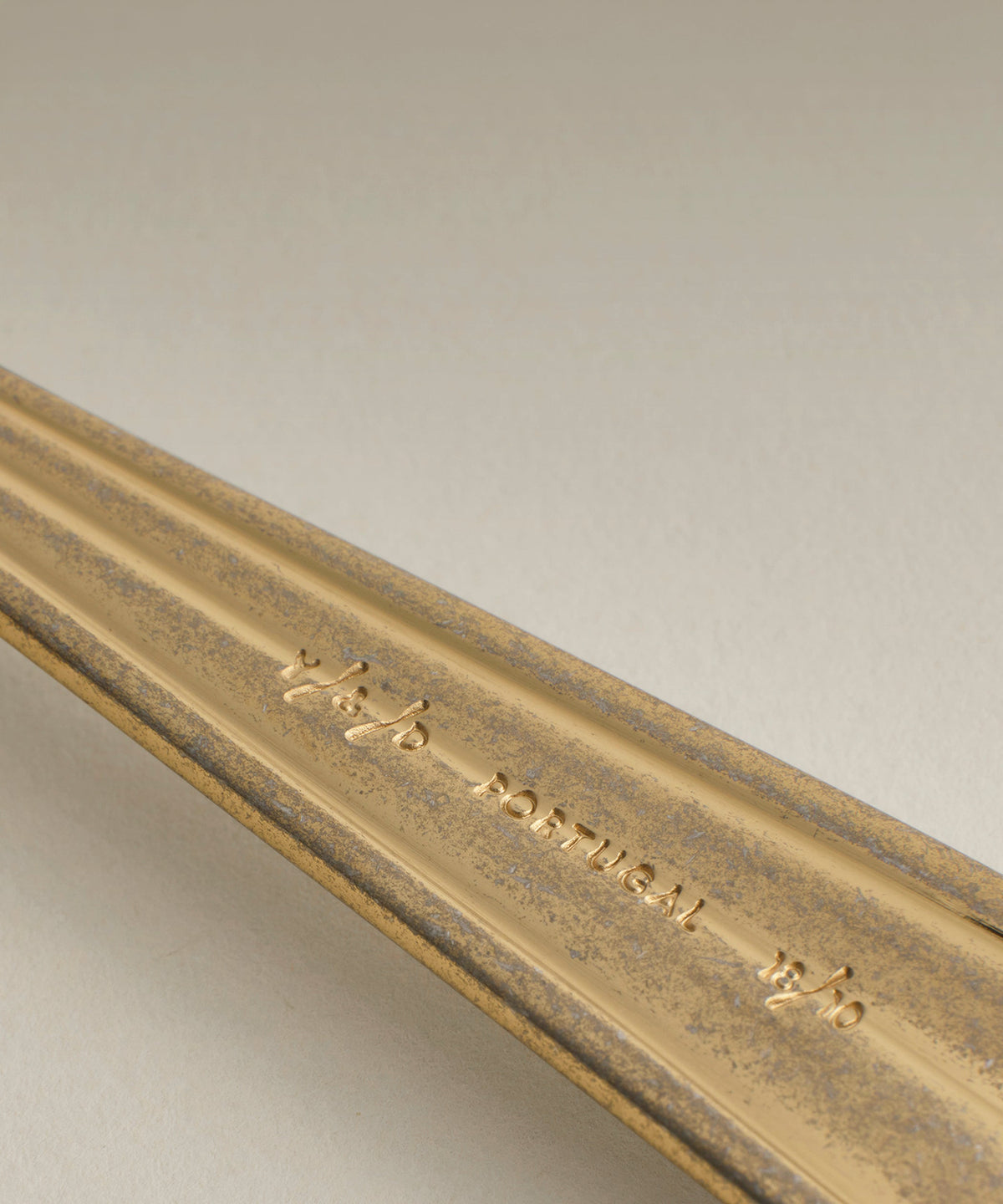 Crescent Serving Fork and Spoon, single piece on a plain surface