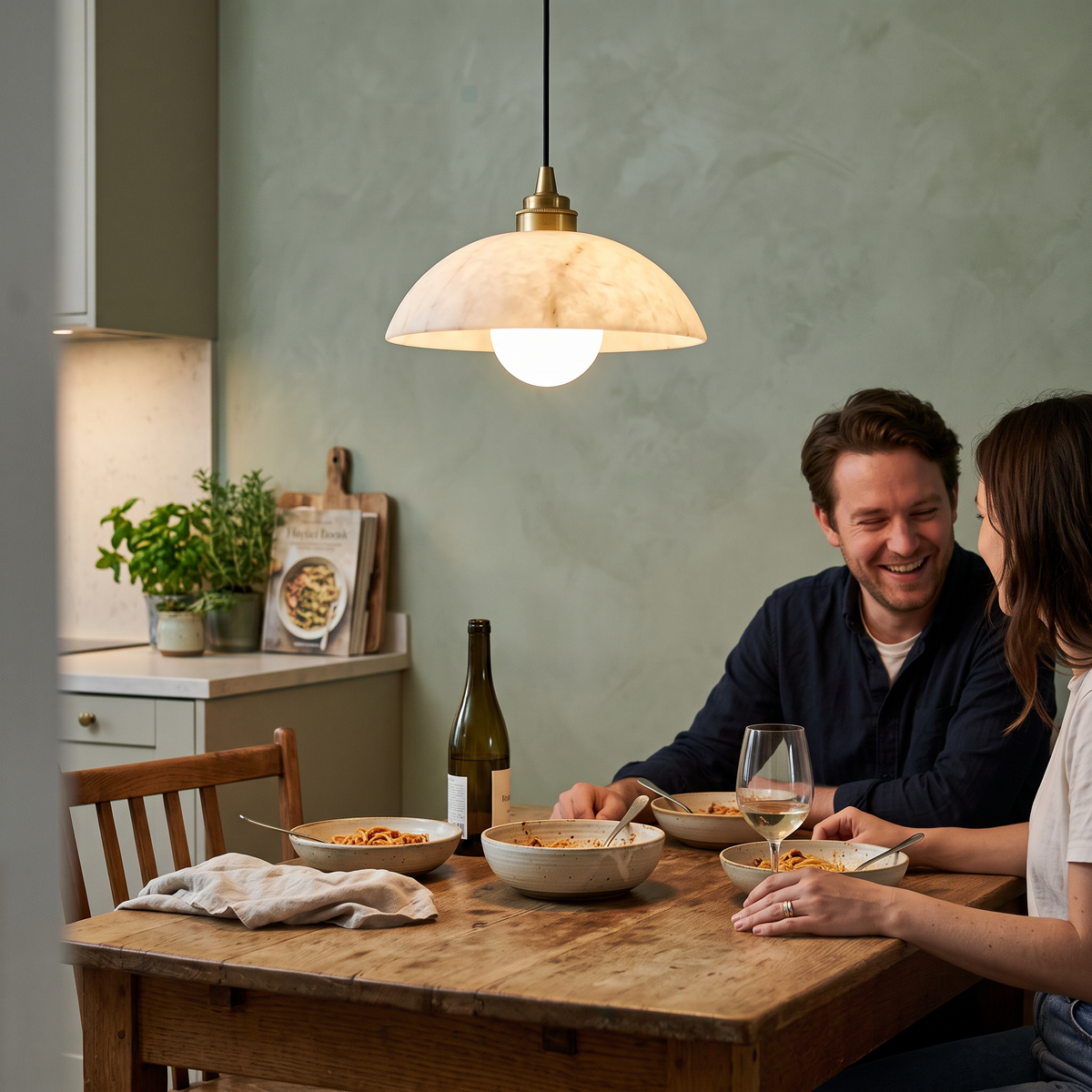 Cupola Alabaster Pendant Light, lit and hanging in a styled room