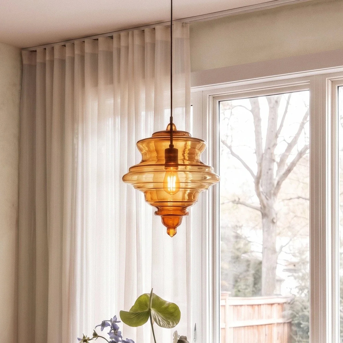 Fadl Metal Pendant Light, second lit and hanging in a styled room