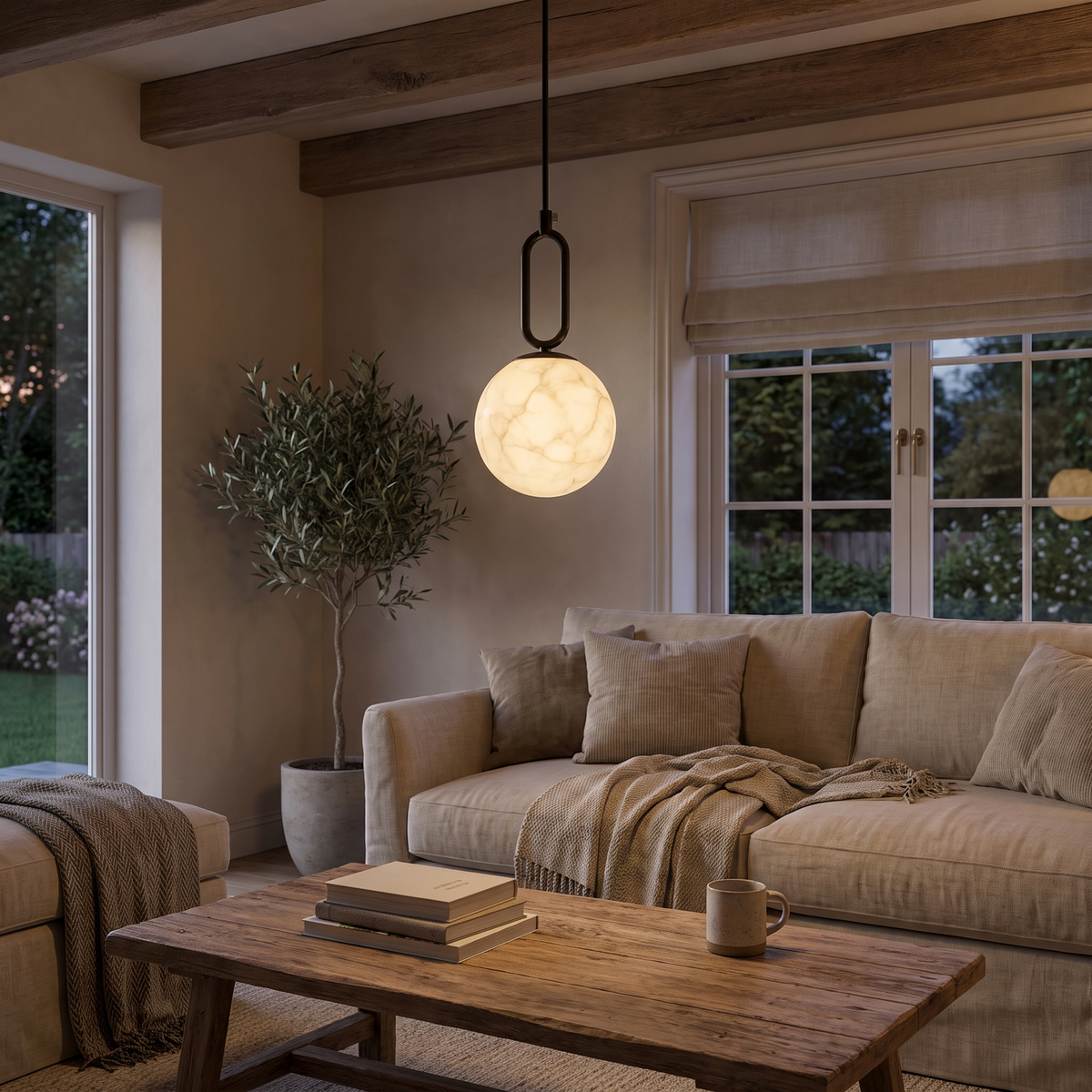 Gong Alabaster Pendant Light, lit and hanging in a styled room