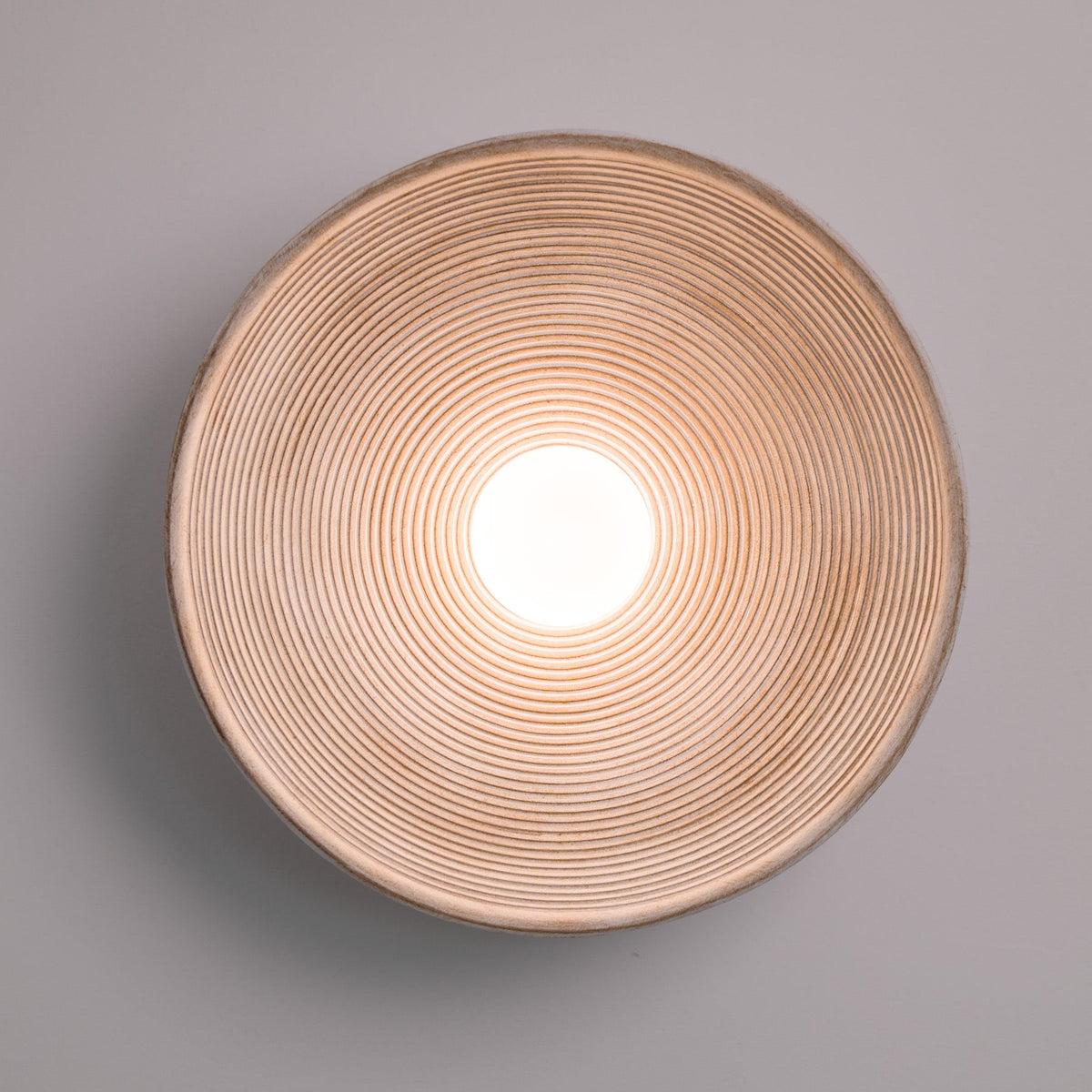 Longleaf Wooden Texture Plate Wall Light In White, styled above a table