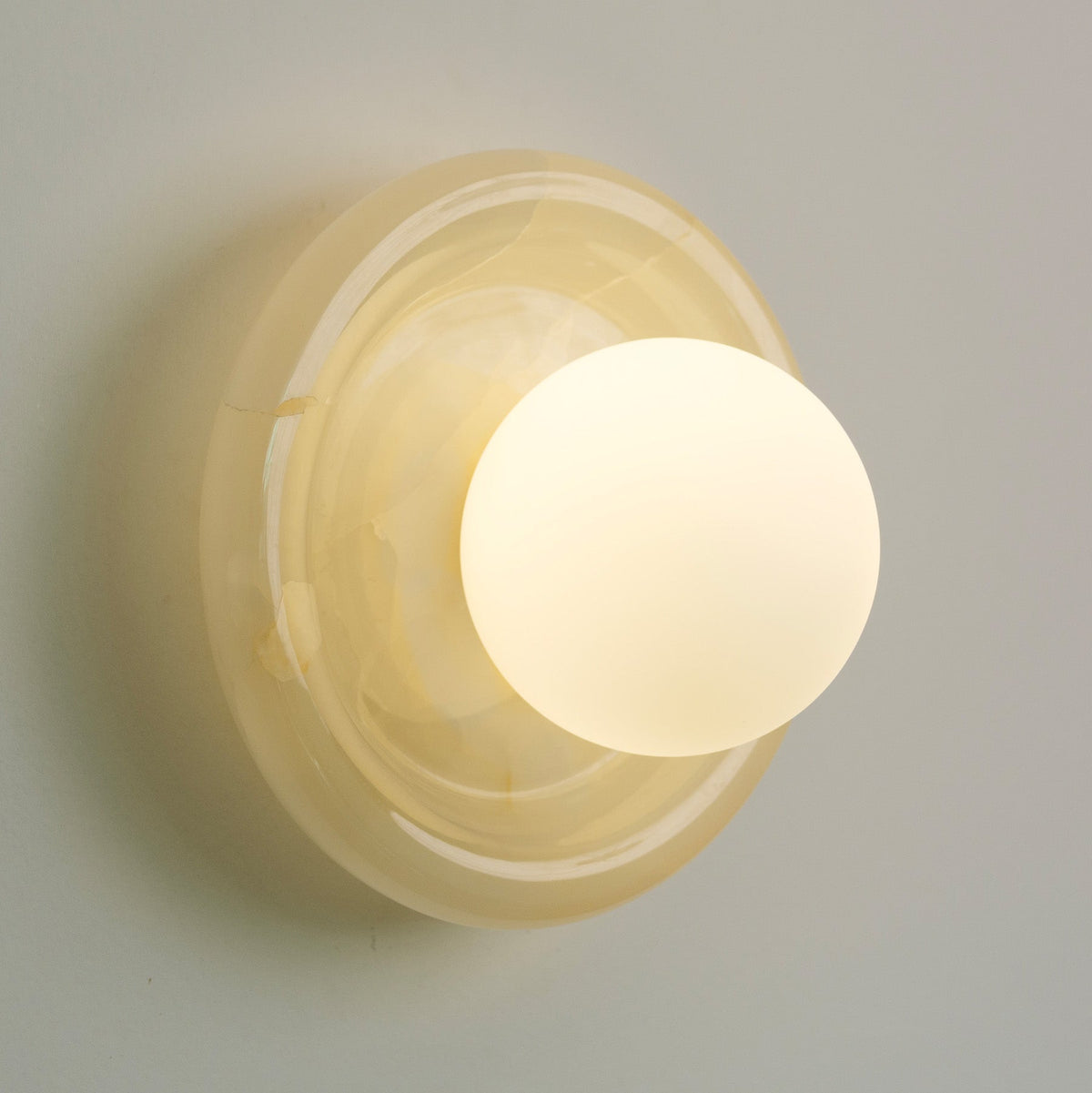 Nara Alabaster Cloud Stone Bubble Plate Wall Light, styled in a hallway