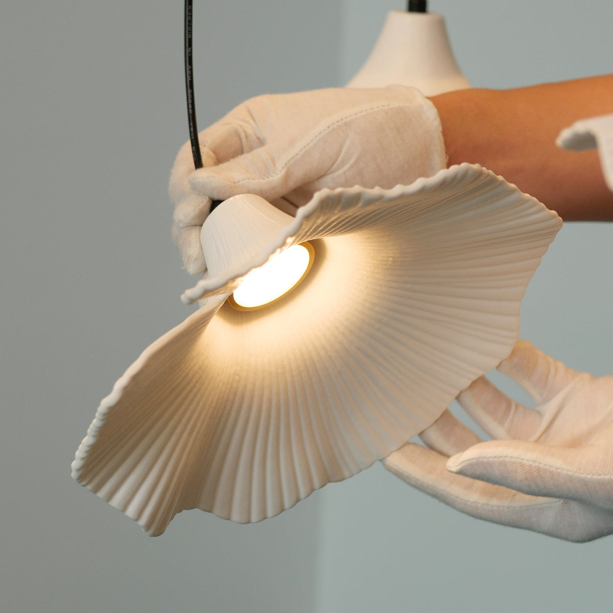 Sculptural Porcelain Ginkgo Leaf Wabi-sabi Pendant Light, lit after dark