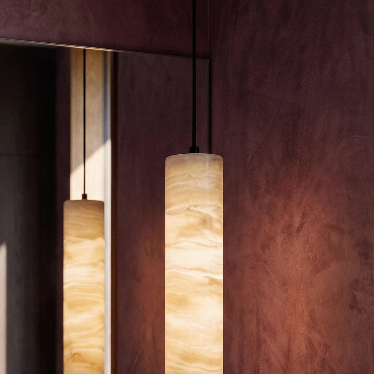 Sten Alabaster Pendant Light, second lit and hanging in a styled room
