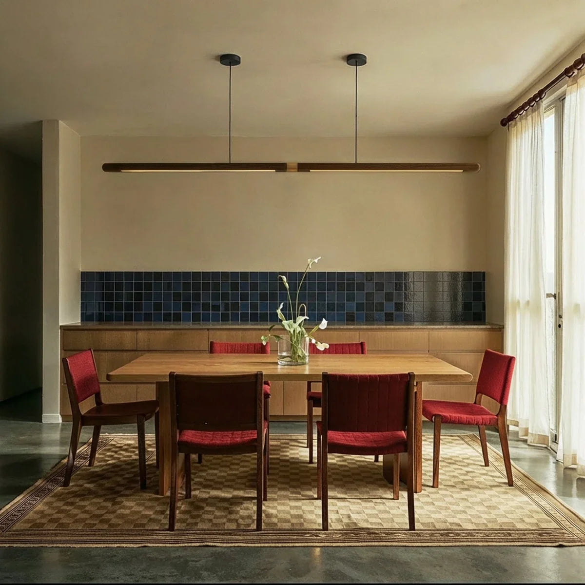 Svelte Walnut Pendant Light, second lit and hanging in a styled room